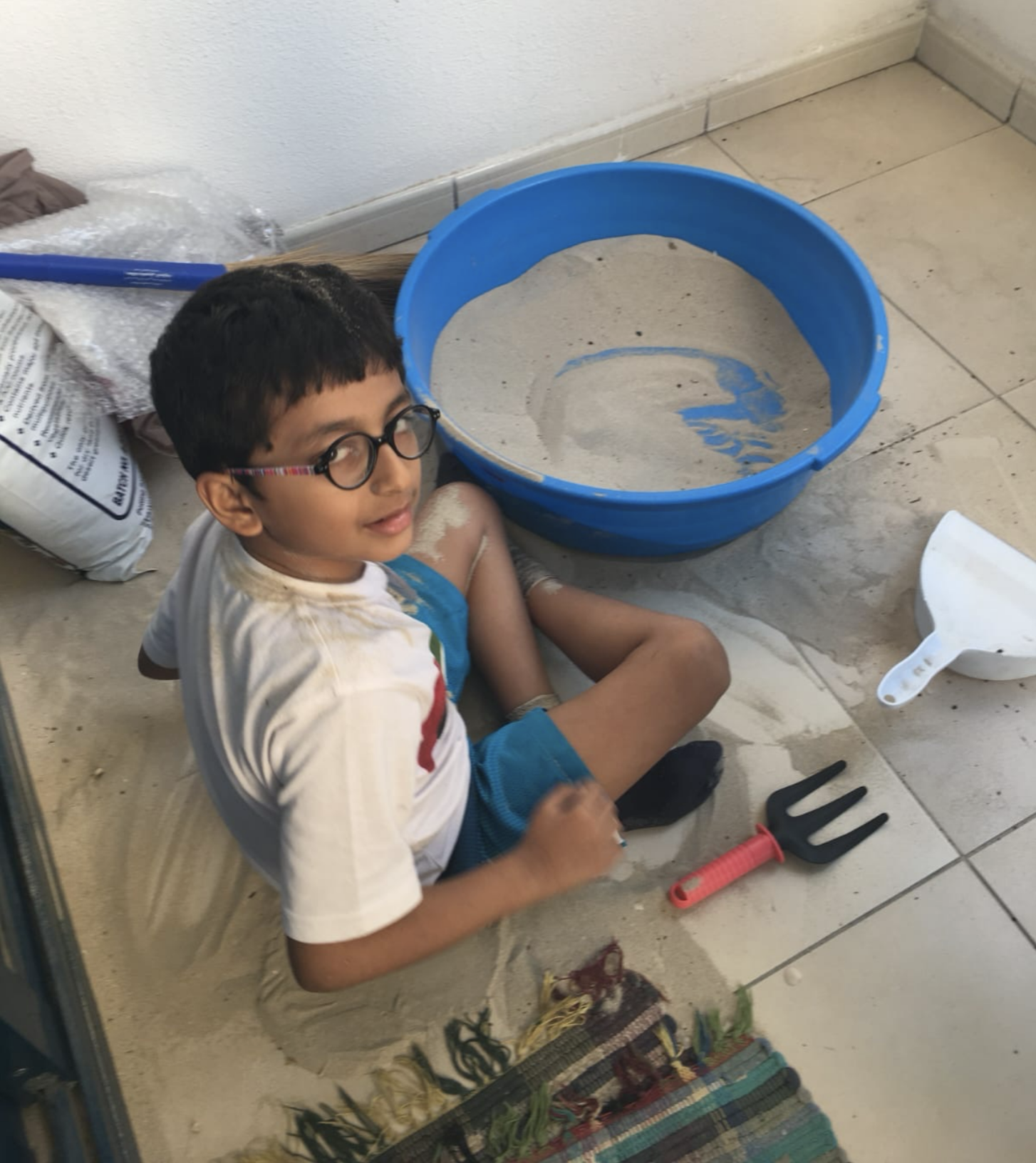 Priya's son playing in the homemade desensory room created by his parents to help him feel engaged through sensory play